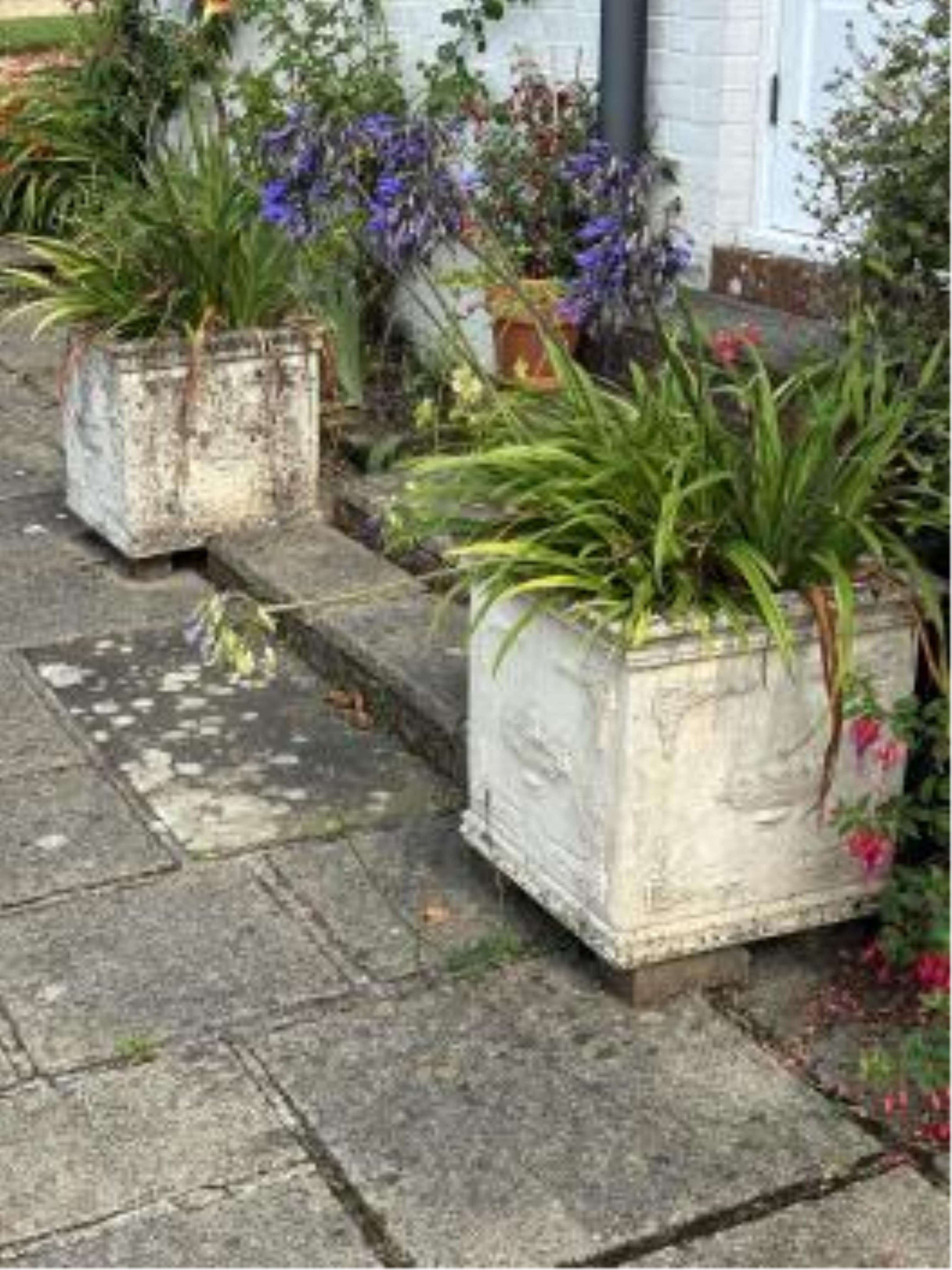 A pair of square reconstituted stone planters, width 50cm, height 49cm, planting removed. Condition - weathered, otherwise good